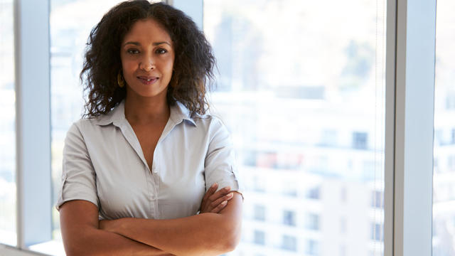 Portrait Of Businesswoman Standing By Window In Office 