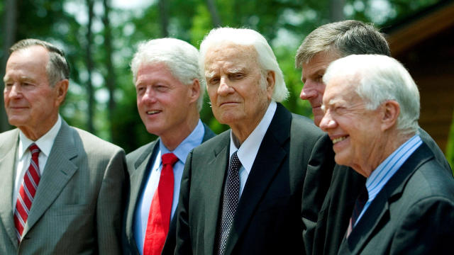 Former Presidents George H.W. Bush, left; Bill Clinton, second left; and Jimmy Carter, right, pose with evangelist Billy Graham and his son Franklin Graham, second right, before the Billy Graham Library dedication on the campus of the Billy Graham Evangel 