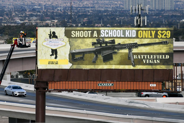 Subversive Art Group Vandalizes Billboard Ad For Battlefield Vegas Machine Gun Range 
