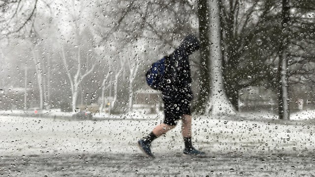 A student walks out of school during a storm in Newtown, Pennsylvania, March 2, 2018. 