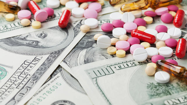 cost medicinal product and treatment concept, pills tablets with cash 