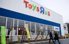 Customers walk in front of the Toys R Us store at Saint-Sebastien-sur-Loire near Nantes 