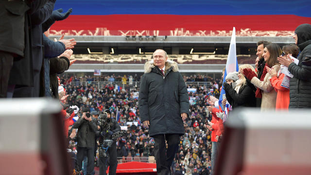 FILE PHOTO: Russian President Putin arrives to take part in a rally to support his bid in the upcoming presidential election, at Luzhniki Stadium in Moscow 