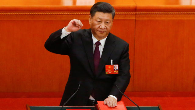 Chinese President Xi Jinping pledges an oath to the Constitution after being confirmed president for another term during the National People's Congress at the Great Hall of the People in Beijing 