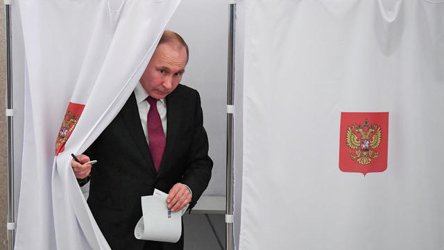 Russian President and Presidential candidate Putin delivers a speech during a rally and concert marking the fourth anniversary of Russia's annexation of the Crimea region, in central Moscow 