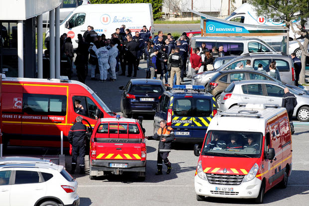 A general view shows rescue forces and police officers at a supermarket after a hostage situation in Trebes 