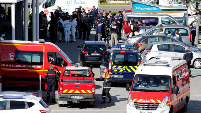 A general view shows rescue forces and police officers at a supermarket after a hostage situation in Trebes 