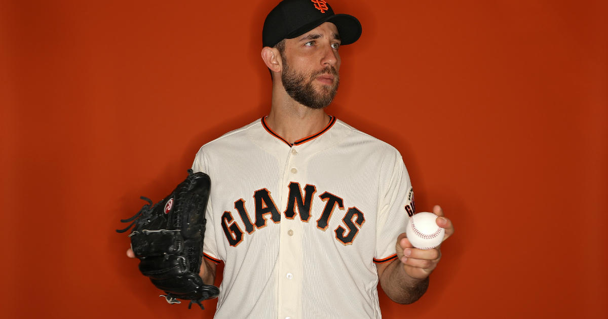 San Francisco Giants Madison Bumgarner blows on his hand during