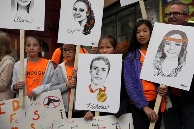 Students hold signs during the "March for Our Lives", an organized demonstration to end gun violence, in downtown Los Angeles, California 