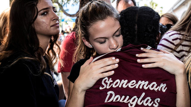 FILE PHOTO: Students from Marjory Stoneman Douglas High School attend a memorial following a school shooting incident in Parkland 
