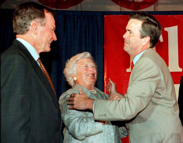 FILE PHOTO: Former President George Bush (L) and wife Barbara congratulate their youngest son Jeb Bush at the Republican gubernatorial candidate's victory party in Miami 