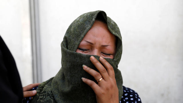 A woman mourns at a hospital after a suicide attack in Kabul 