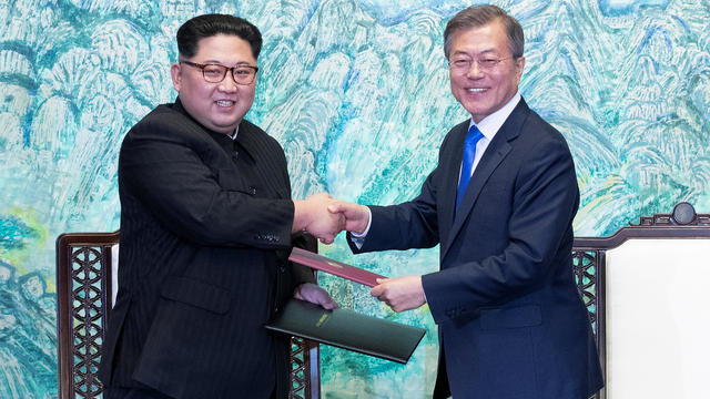 South Korean President Moon Jae-in and North Korean leader Kim Jong Un shake hands at the truce village of Panmunjom 
