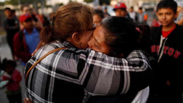 A member of a migrant caravan from Central America hugs an evangelical faithful as they pray in preparation for an asylum request in the U.S., in Tijuana 