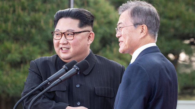 South Korean President Moon Jae-in and North Korean leader Kim Jong Un shake hands at the truce village of Panmunjom 