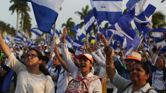 People take part in a protest march to demand an end to violence in Managua 