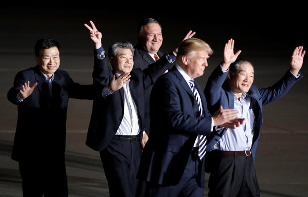 The three Americans formerly held hostage in North Korea gesture next to U.S.President Donald Trump and Secretary of State Mike Pompeo, upon their arrival at Joint Base Andrews 