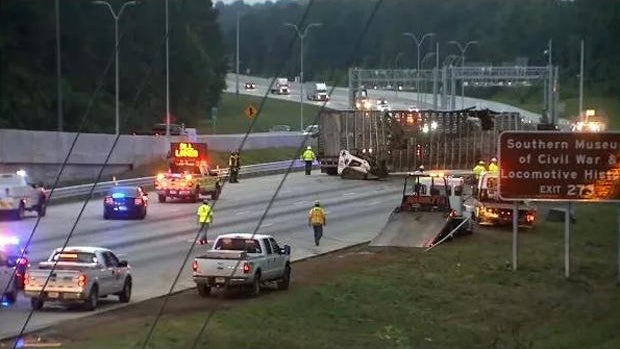 Crews work the scene after a tractor-trailer carrying cows overturned on Interstate 75 near Kennesaw, Georgia, on May 17, 2018. 
