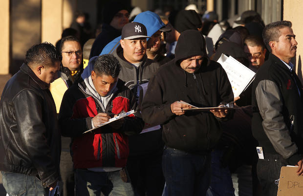 GRANADA HILLS, CA - JANUARY 2, 2015:  Immigrants  without legal status line up to apply for Californ 