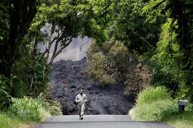 A Hawaii National Guard soldier measures sulfur dioxide gas levels at a lava flow on Highway 137 southeast of Pahoa 