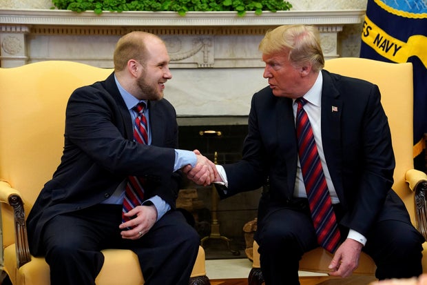 U.S. President Donald Trump shakes hands with Josh Holt, an American missionary who was released by Venezuela, in the Oval Office of the White House in Washington