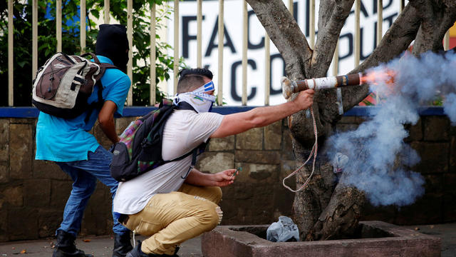 A demonstrator fires a homemade mortar towards riot police during a protest against Nicaragua's President Daniel Ortega's government in Managua 