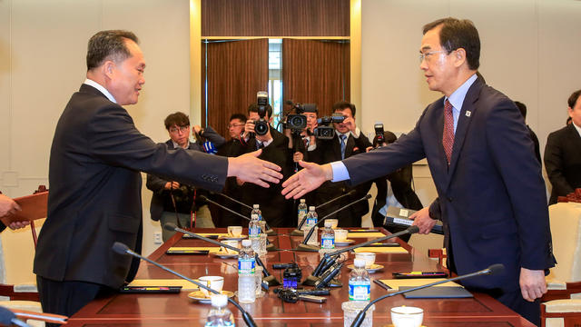 South Korean Unification Minister Cho Myoung-gyon shakes hands with his North Korean counterpart Ri Son Gwon during their meeting at the truce village of Panmunjom 