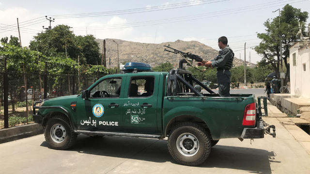 Afghan police officer keeps watch at the site of a blast in Kabul 