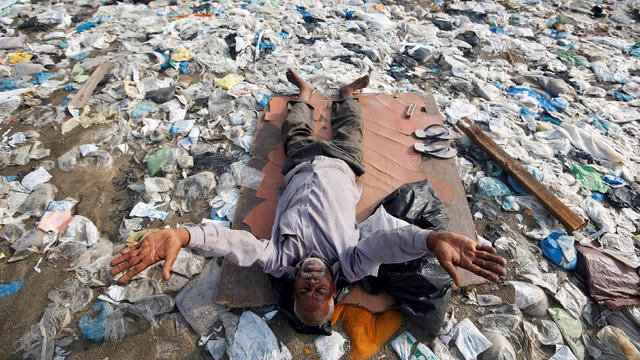 A man exercises on a garbage-strewn beach on World Environment Day in Mumbai 