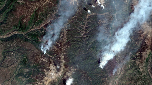 A satellite image shows the Burro Wildfire (L) and the 416 Wildfire burning west of Highway 550 and northwest of Durango, Colorado 