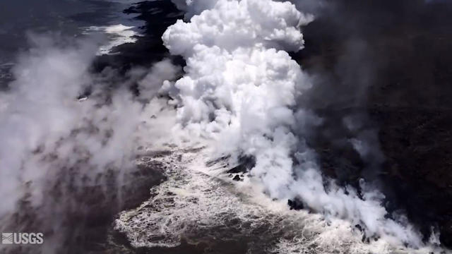 A screen capture from aerial footage posted to the U.S. Geological Survey's Facebook page shows steam rising from where molten lava comes into contact with the Pacific Ocean along the coast of Hawaii on June 11, 2018. 