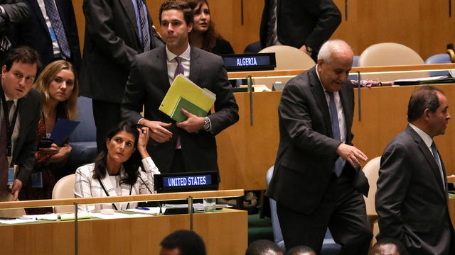 Palestinian Ambassador to the United Nations Riyad Mansour passes U.S. Ambassador Nikki Haley during a vote at U.N. headquarters in New York 