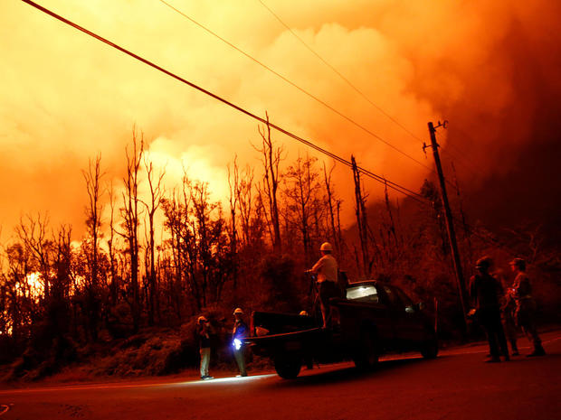 Journalists and National Guard soldiers watch as lava erupts in Leilani Estates 