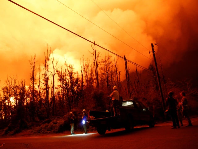 Journalists and National Guard soldiers watch as lava erupts in Leilani Estates 