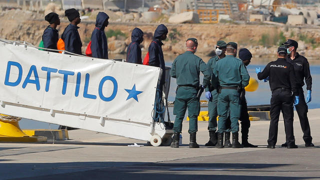 Refugees disembark the Dattilo Italian coast guard ship in the port in Valencia 