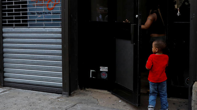 A child is seen entering the Cayuga Center, which provides foster care and other services to immigrant children separated from their families in New York 