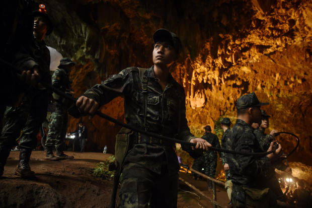 Thai soldiers relay electric cable deep into the Tham Luang cave at the Khun Nam Nang Non Forest Park in Chiang Rai, Thailand, on June 26, 2018, during a rescue operation for a missing children's soccer team and their coach. 