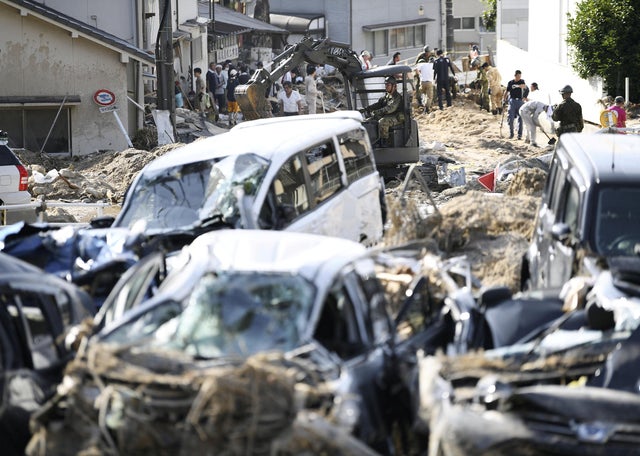 People clear debris caused by torrential rain at Aki ward in Hiroshima 