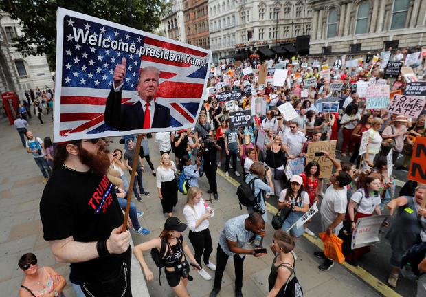 A man holds a pro-Trump banner as demonstrators protest against the visit of U.S. President Donald Trump, in central London 