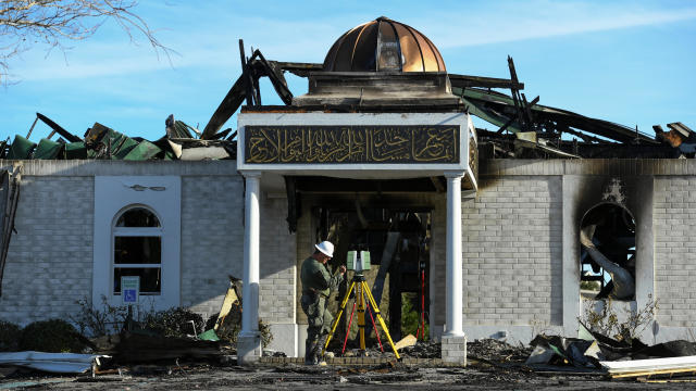 A security official investigates the aftermath of a fire at the Victoria Islamic Center mosque in Victoria, Texas 