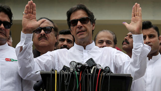 Imran Khan speaks to members of media after casting his vote at a polling station during the general election in Islamabad 