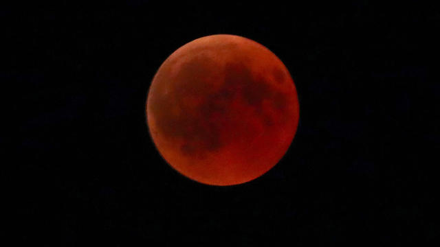 A "blood moon" is seen during a full lunar eclipse in the southern Bavarian village of Raisting 