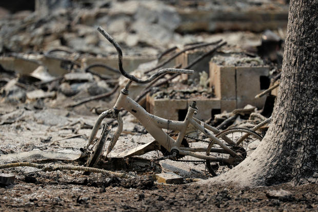 A charred child's bike at a home that burned in the Carr Fire is seen west of Redding 