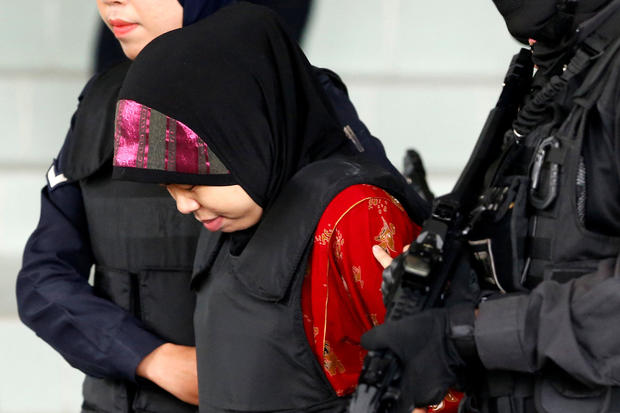 Indonesian Siti Aisyah is escorted as she leaves the Shah Alam High Court on the outskirts of Kuala Lumpur 