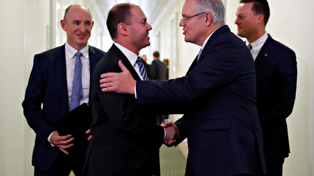 Incoming Australian Prime Minister Scott Morrison is congratulated by his new deputy Josh Frydenberg after a party meeting in Canberra 