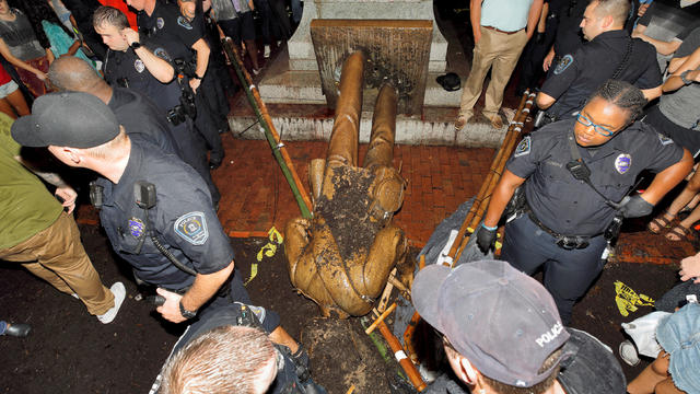 University of North Carolina police surround the toppled statue of a Confederate soldier nicknamed Silent Sam on the school's campus after a demonstration for its removal 