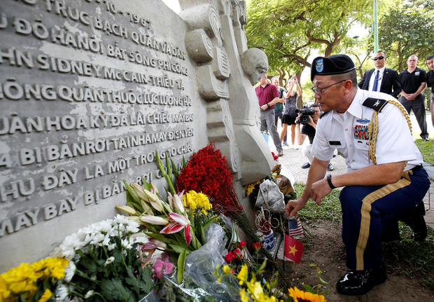 Military Attache Ton Tuan from U.S. Embassy places incense while he pays respect in memory of the late U.S. Senator John McCain (R-AZ) at the McCain Memorial in Hanoi 