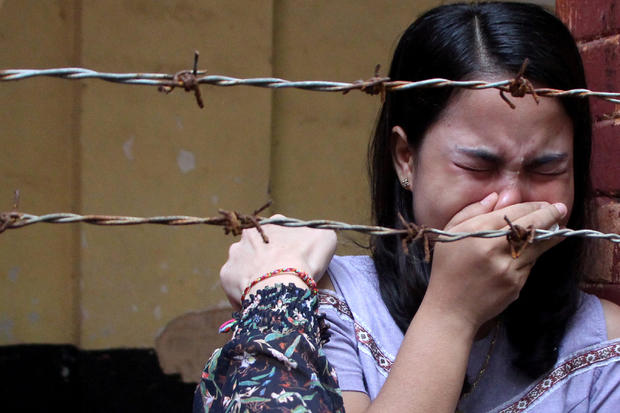 Wife of Reuters journalist Kyaw Soe Oo reacts after listening to the the verdict at Insein court in Yangon 