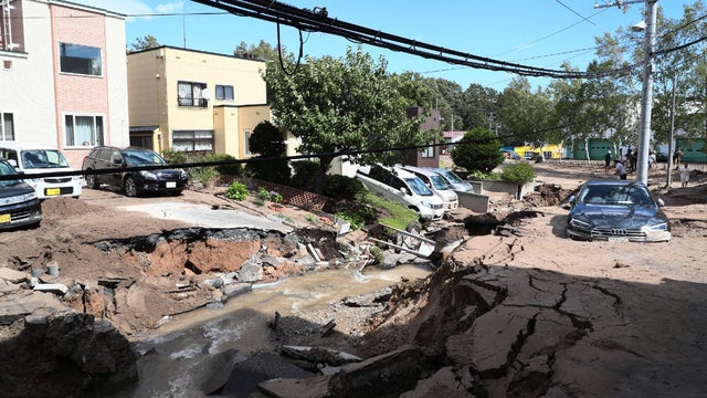 People look at an area damaged by an earthquake in Sapporo 