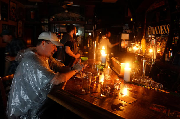 People sit at a bar that has no power and drink during a "Hurricane Party" as Hurricane Florence comes ashore on Wilmington 